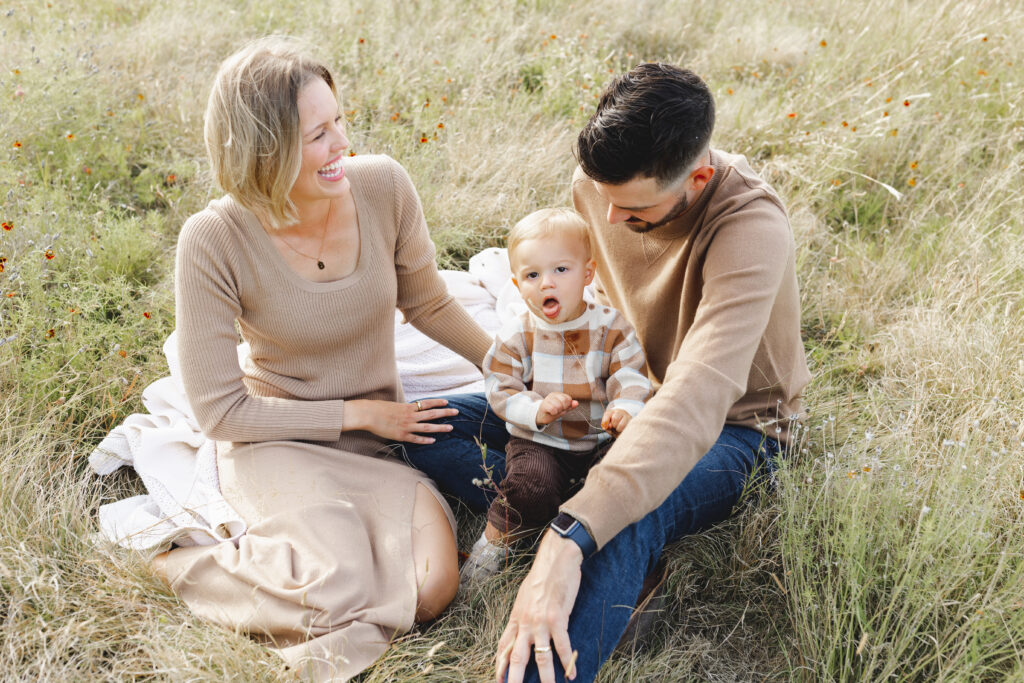 College Station Family sitting in a field