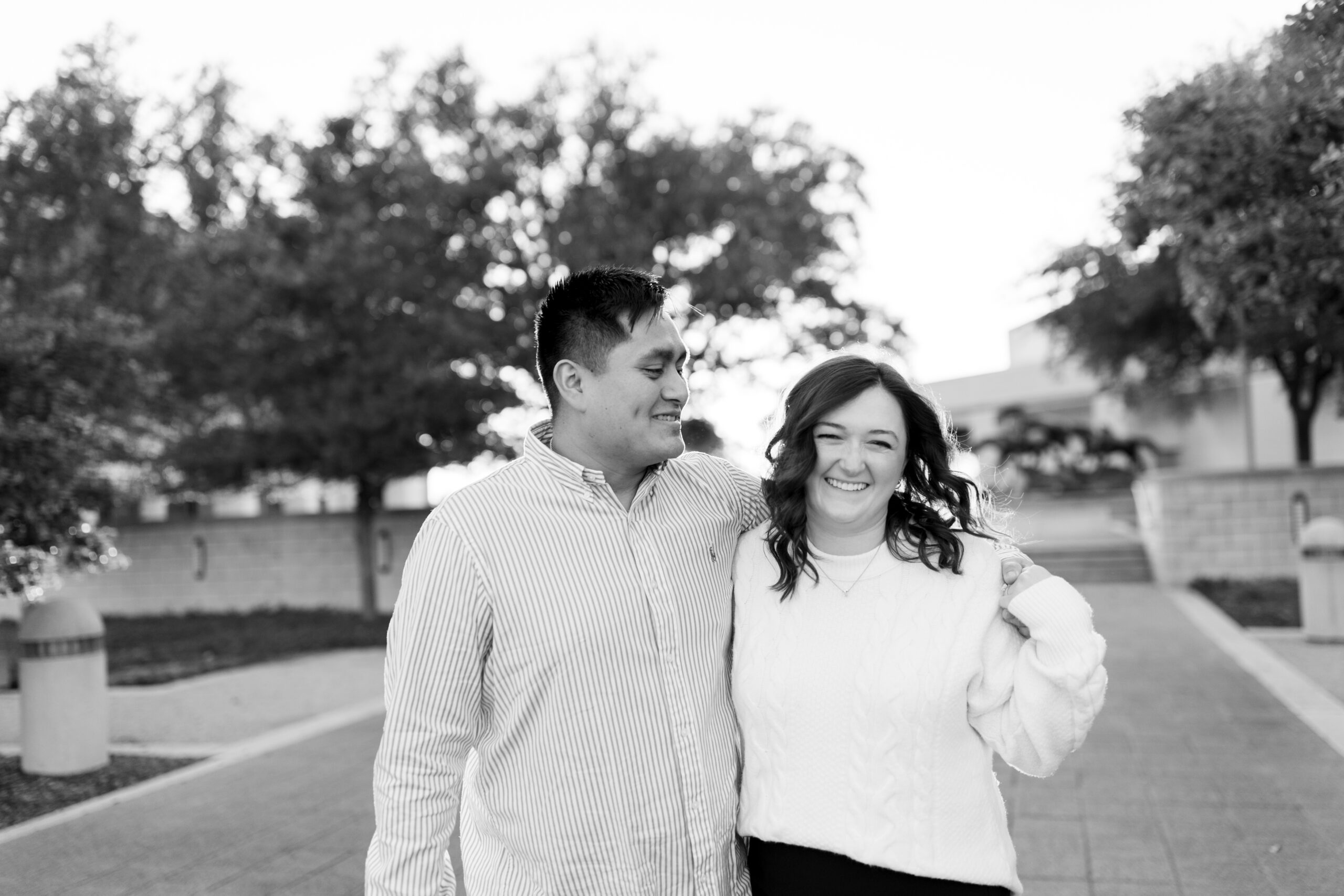 A college station engaged couple walking together