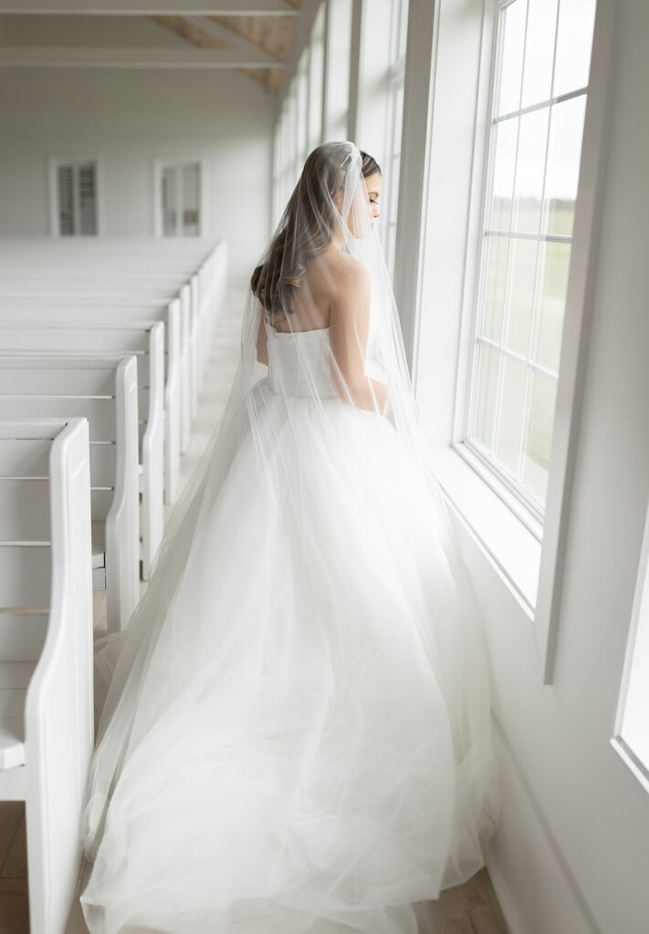 Bridal portrait in bright and airy chapel