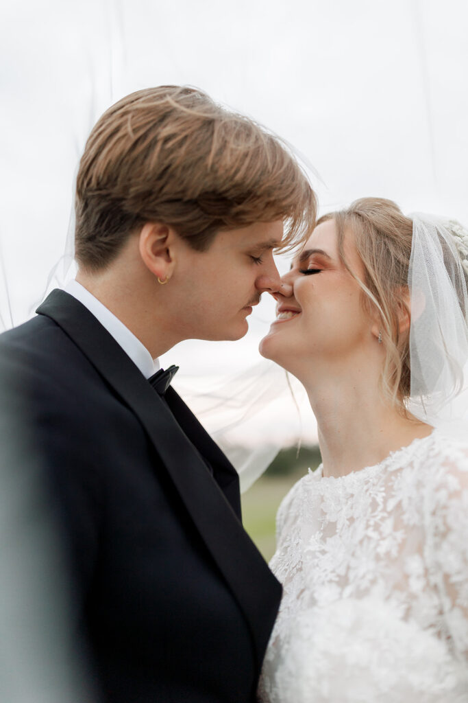 bride and groom kissing at camp hosea