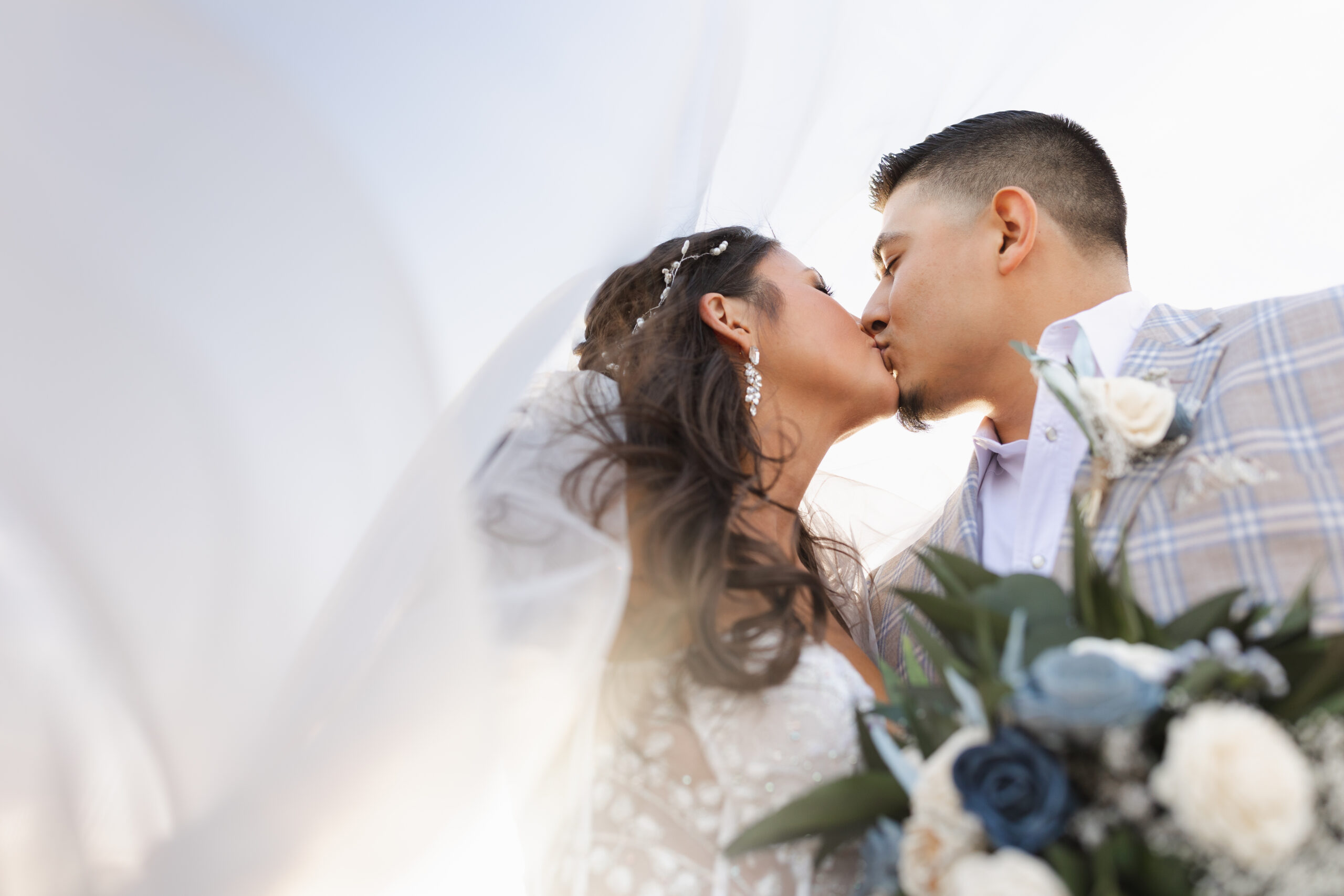 a bride and groom kiss on their wedding day in west texas