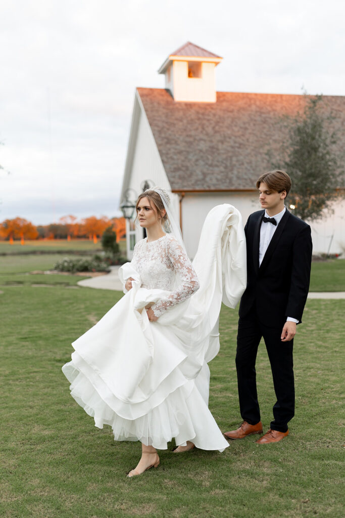 bride and groom in front of chapel in college station