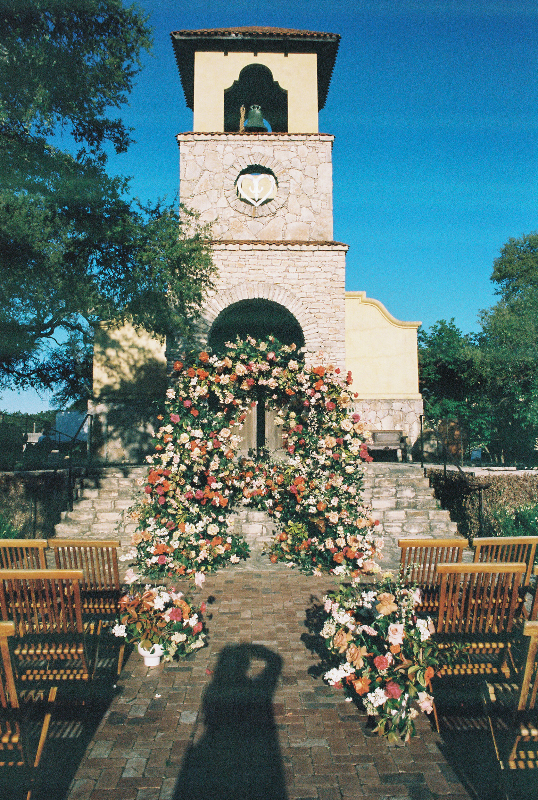 camp lucy chapel with a luxury wedding flower arch