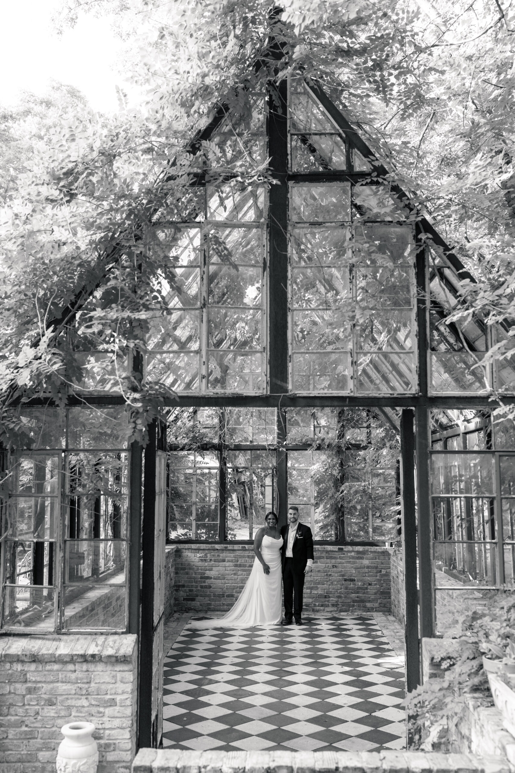 Bride and Groom standing in greenhouse at Sekrit Theater