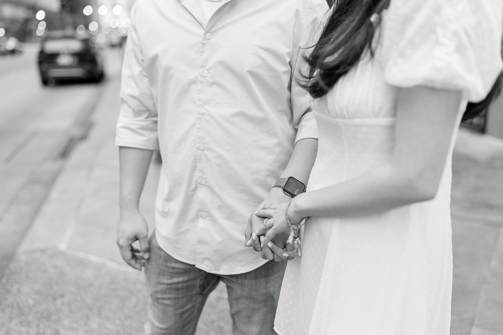 couple holding hands in downtown houston engagement session