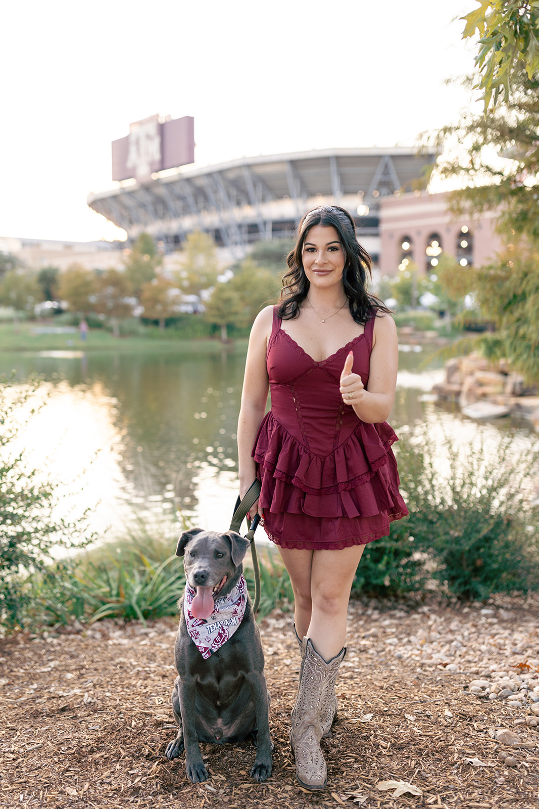 Texas A&M Senior posing with dog in front of Kyle field